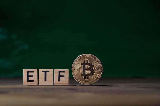 Physical representation of Bitcoin on a table with scrabble letters spelling out ETF.